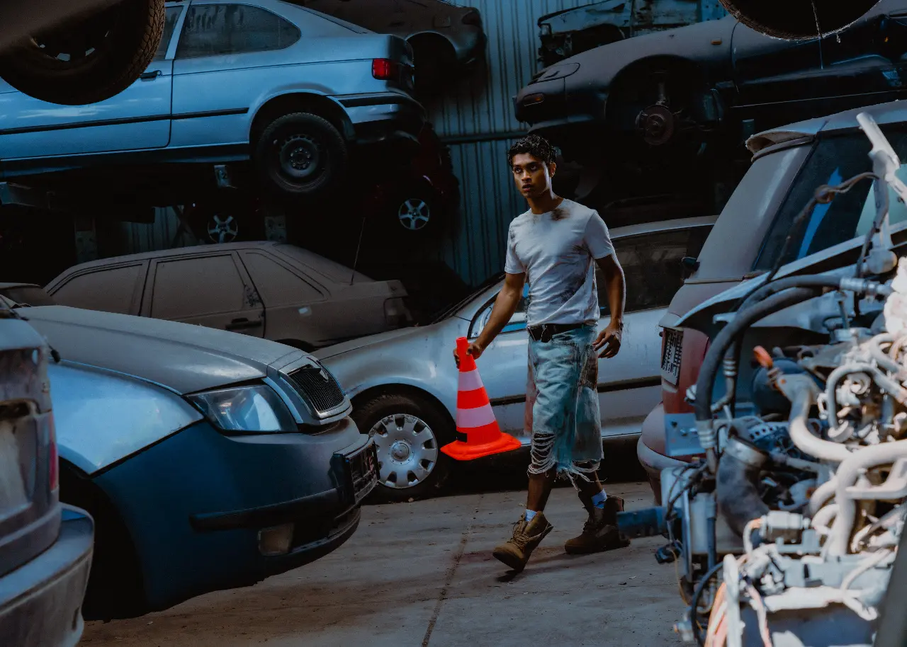 Person walking through a vehicle yard while reviewing a route